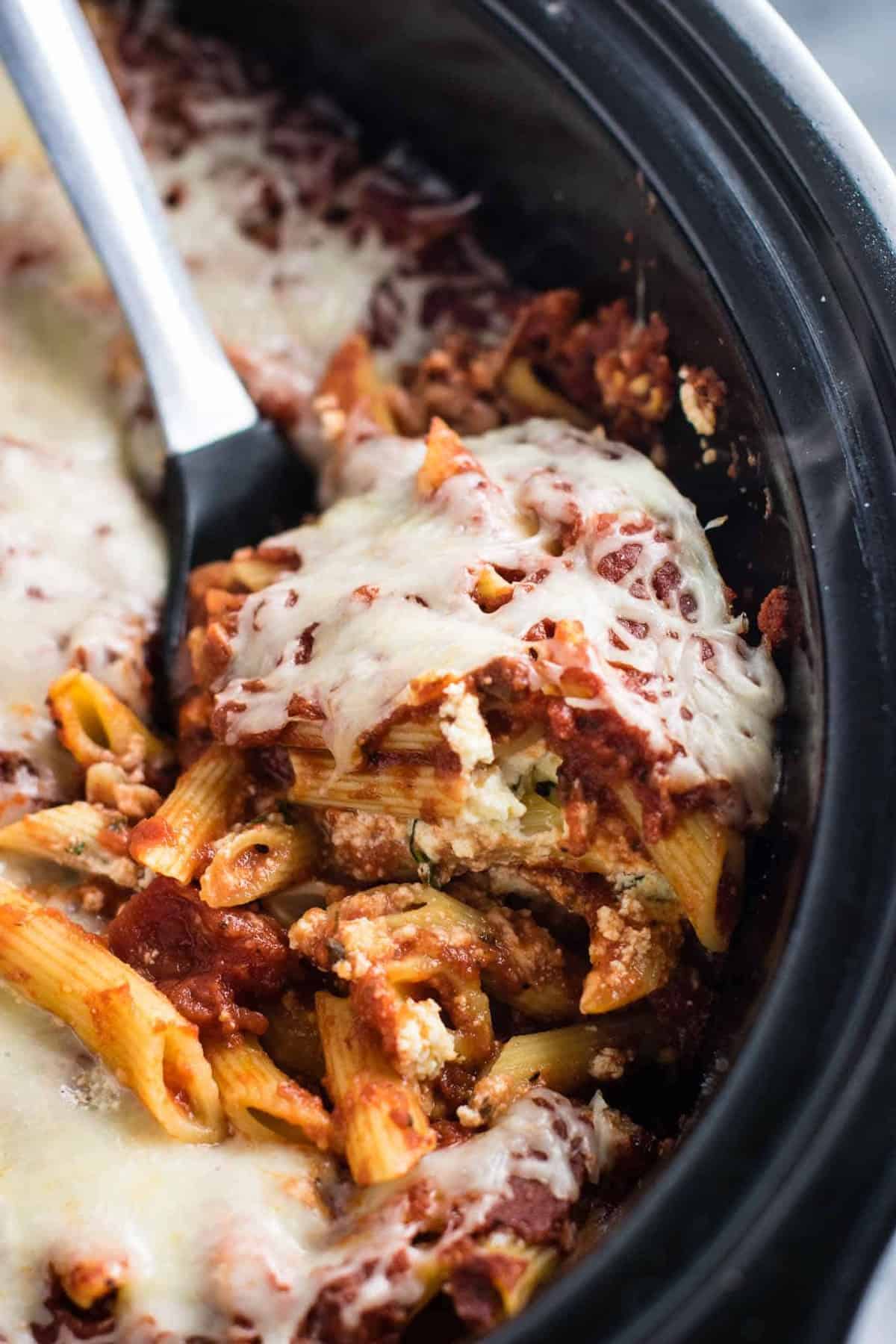 This Easy Crockpot Baked Ziti gets RAVE reviews. Everyone loves this when I make it! So simple to assemble and you don’t even have to cook the noodles first! #crockpotbakedziti #ziti #pasta #slowcooker