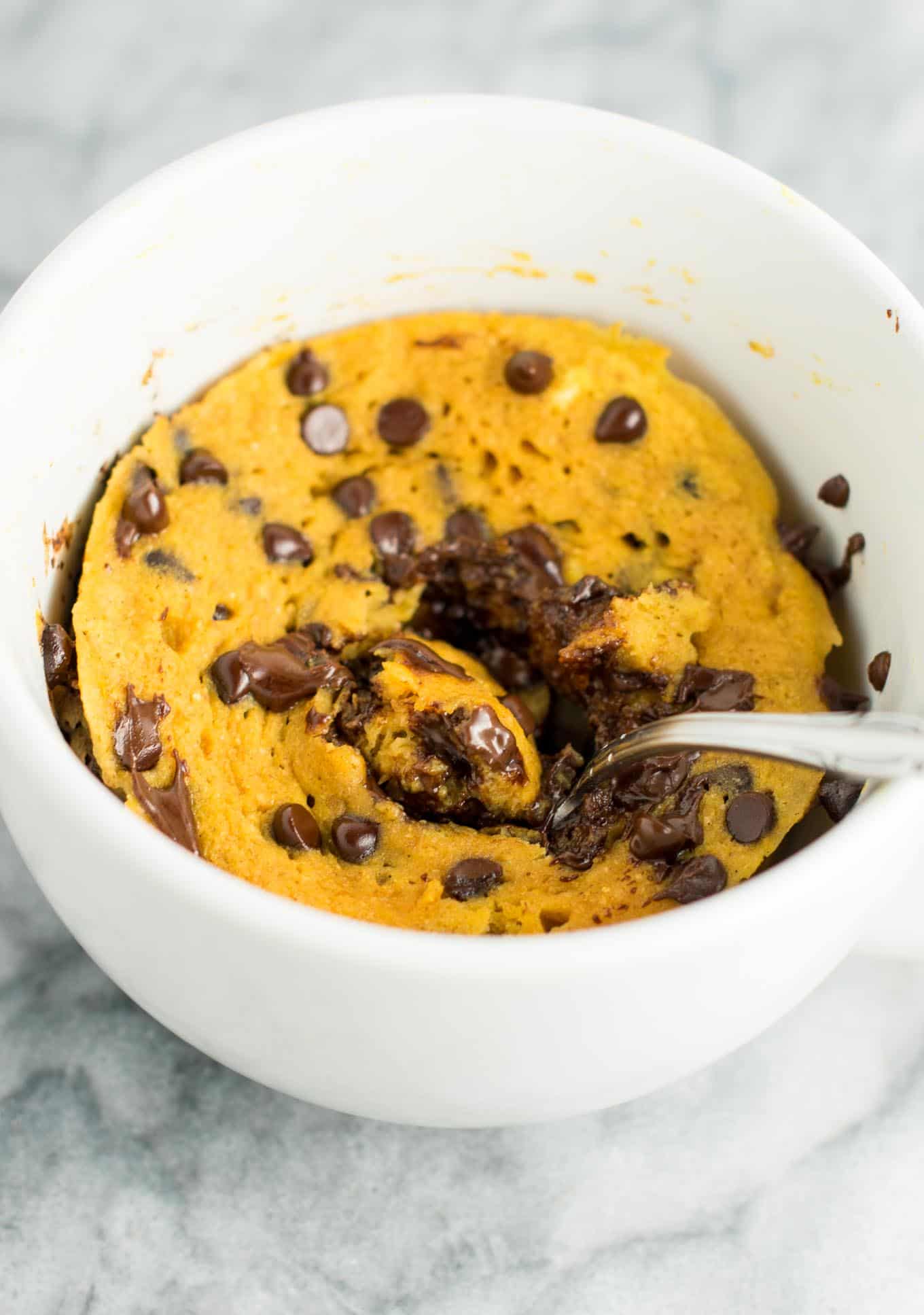 a spoon inside a pumpkin mug cake