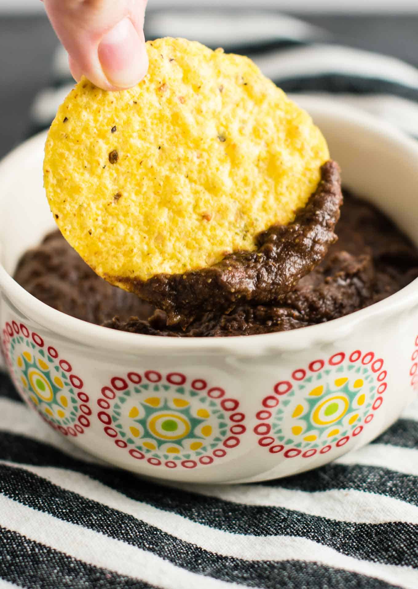 Learn how to make refried beans with just black beans, lime, and a few simple spices. I make this recipe all the time!