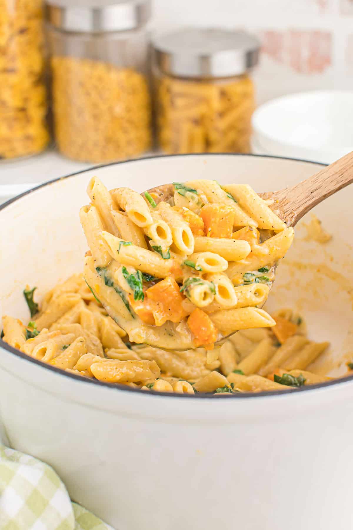 scooping sweet potato pasta from the dutch oven