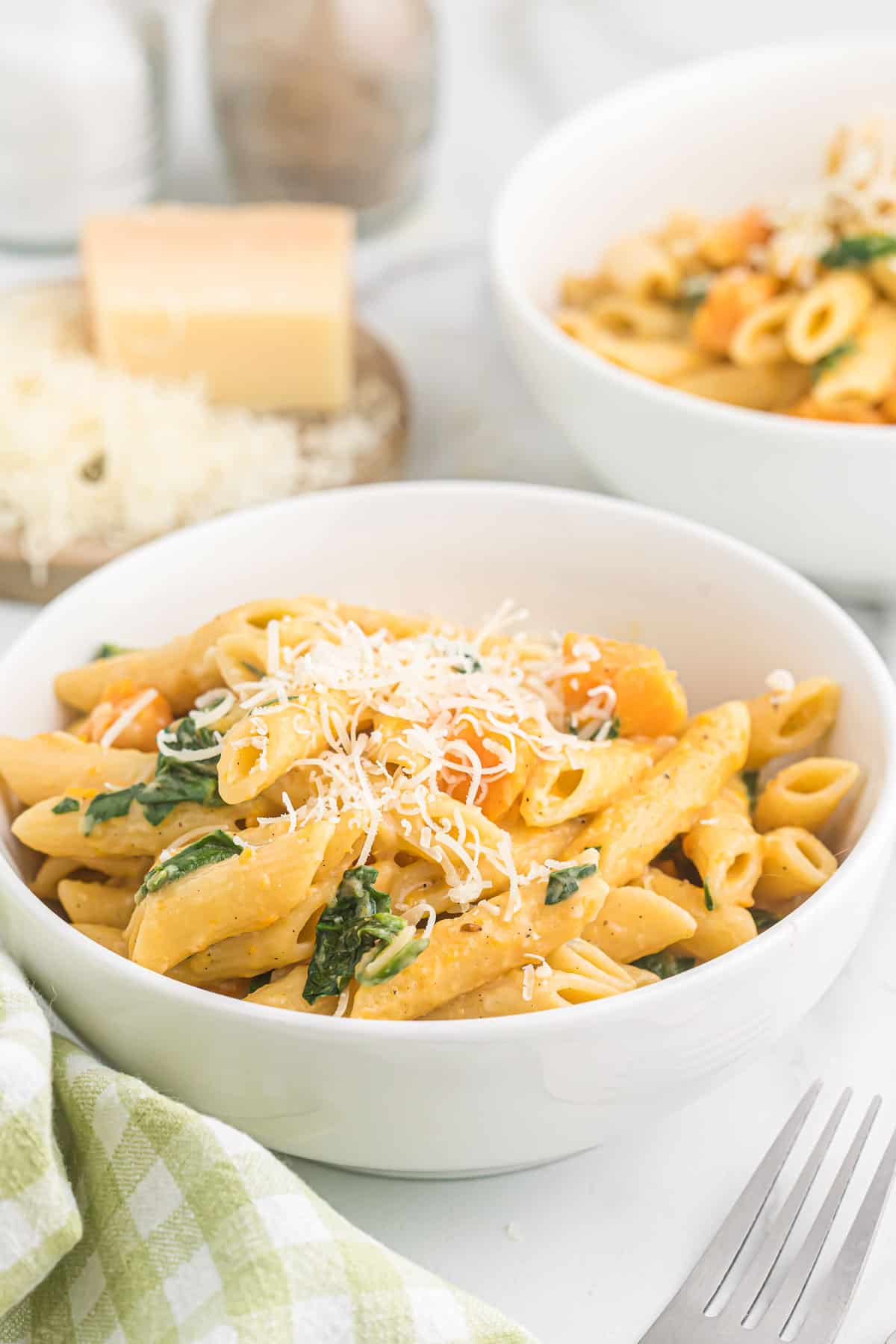 sweet potato pasta in a bowl topped with parmesan cheese