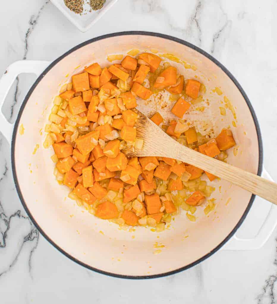 stirring the garlic, onion, and sweet potatoes