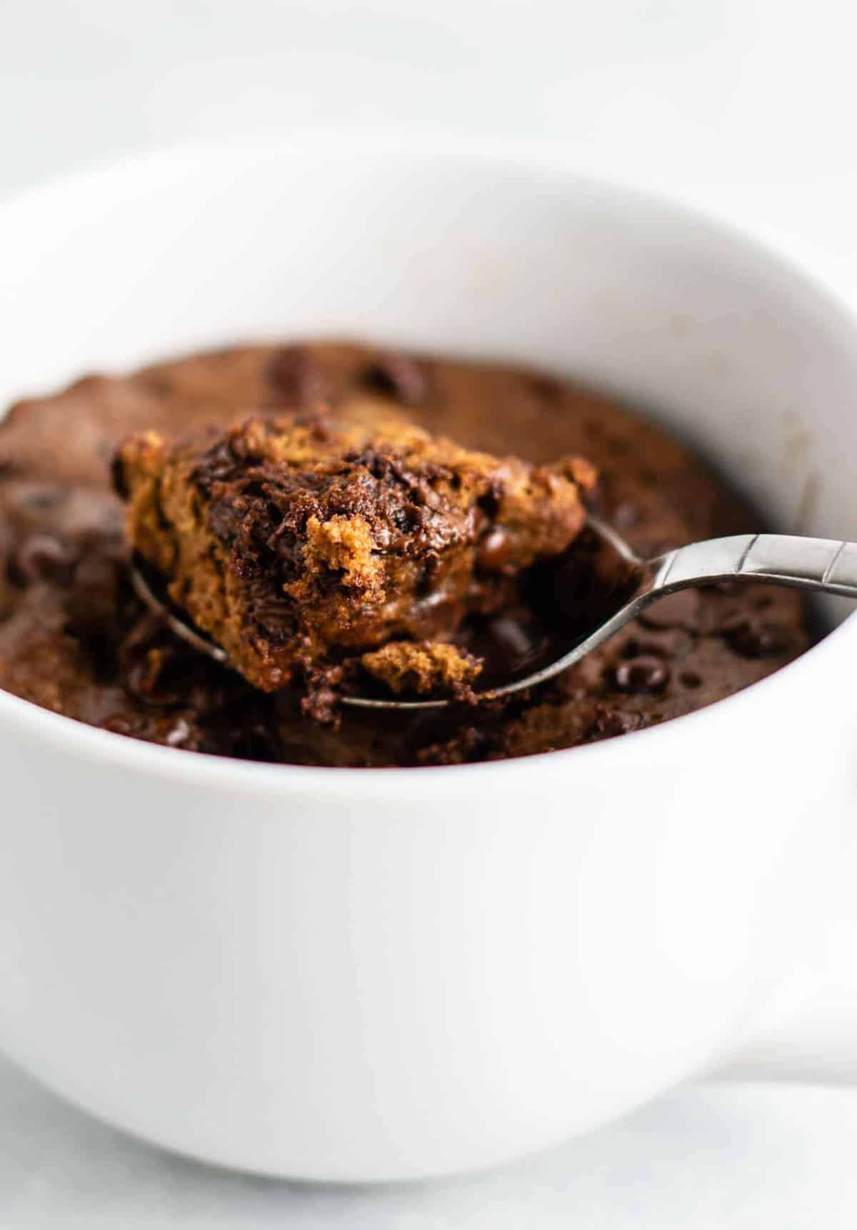 Gluten free chocolate mug cake made with easy to find flours. Perfectly fluffy and so decadent - serve with ice cream!