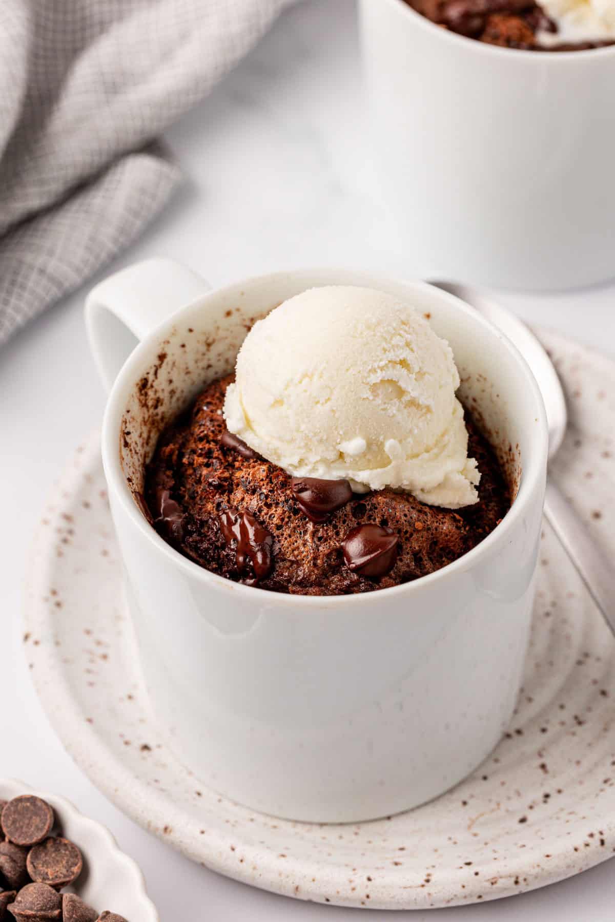 chocolate protein mug cake topped with vanilla ice cream
