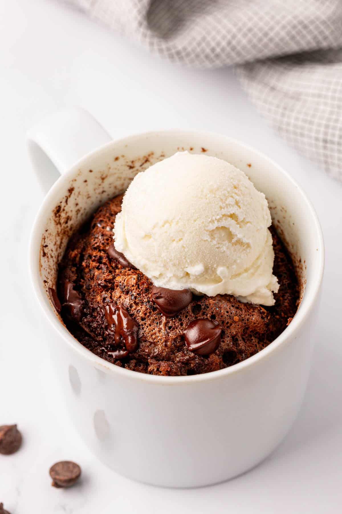 chocolate protein mug cake topped with vanilla ice cream