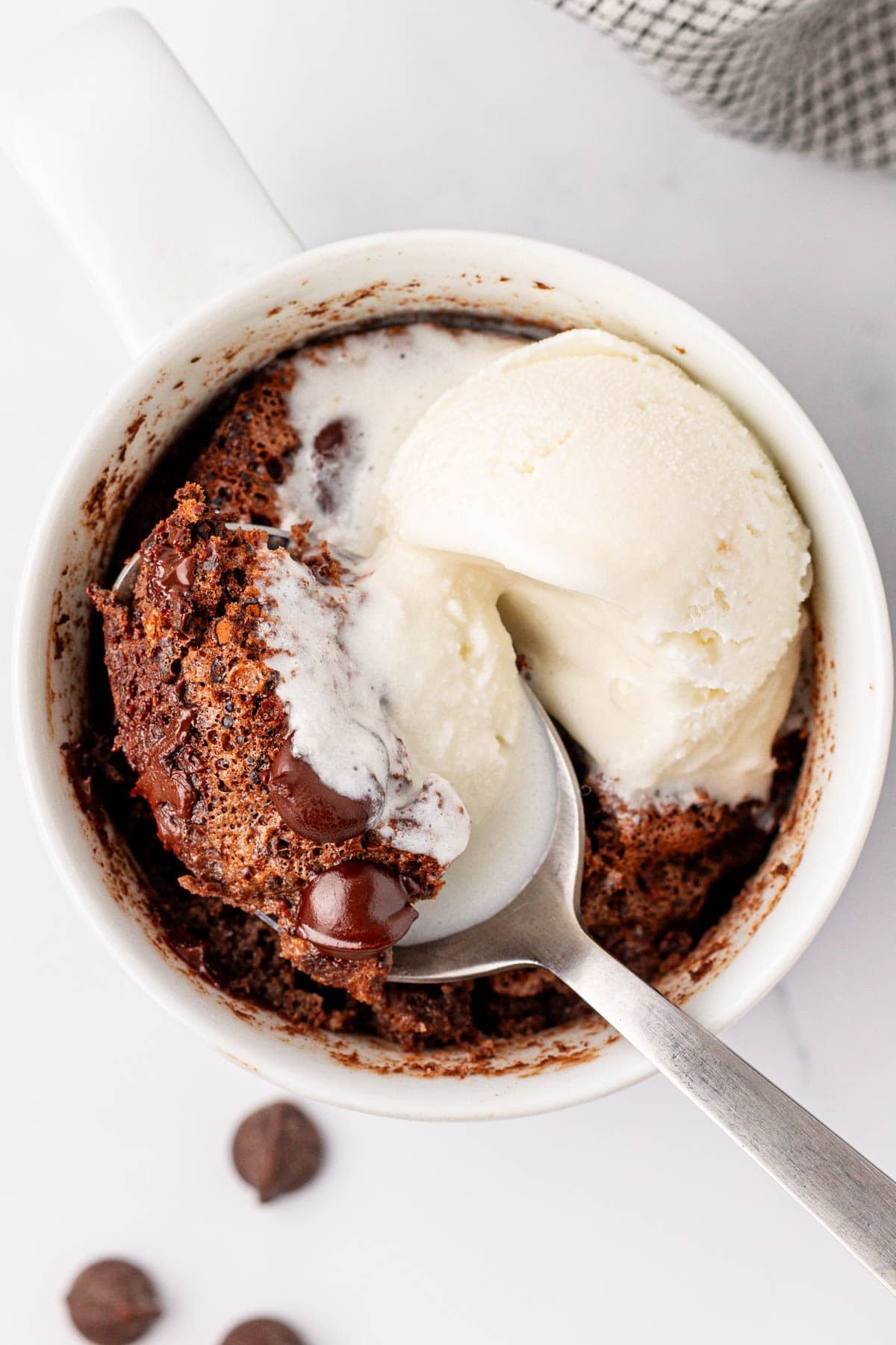 chocolate protein mug cake topped with vanilla ice cream