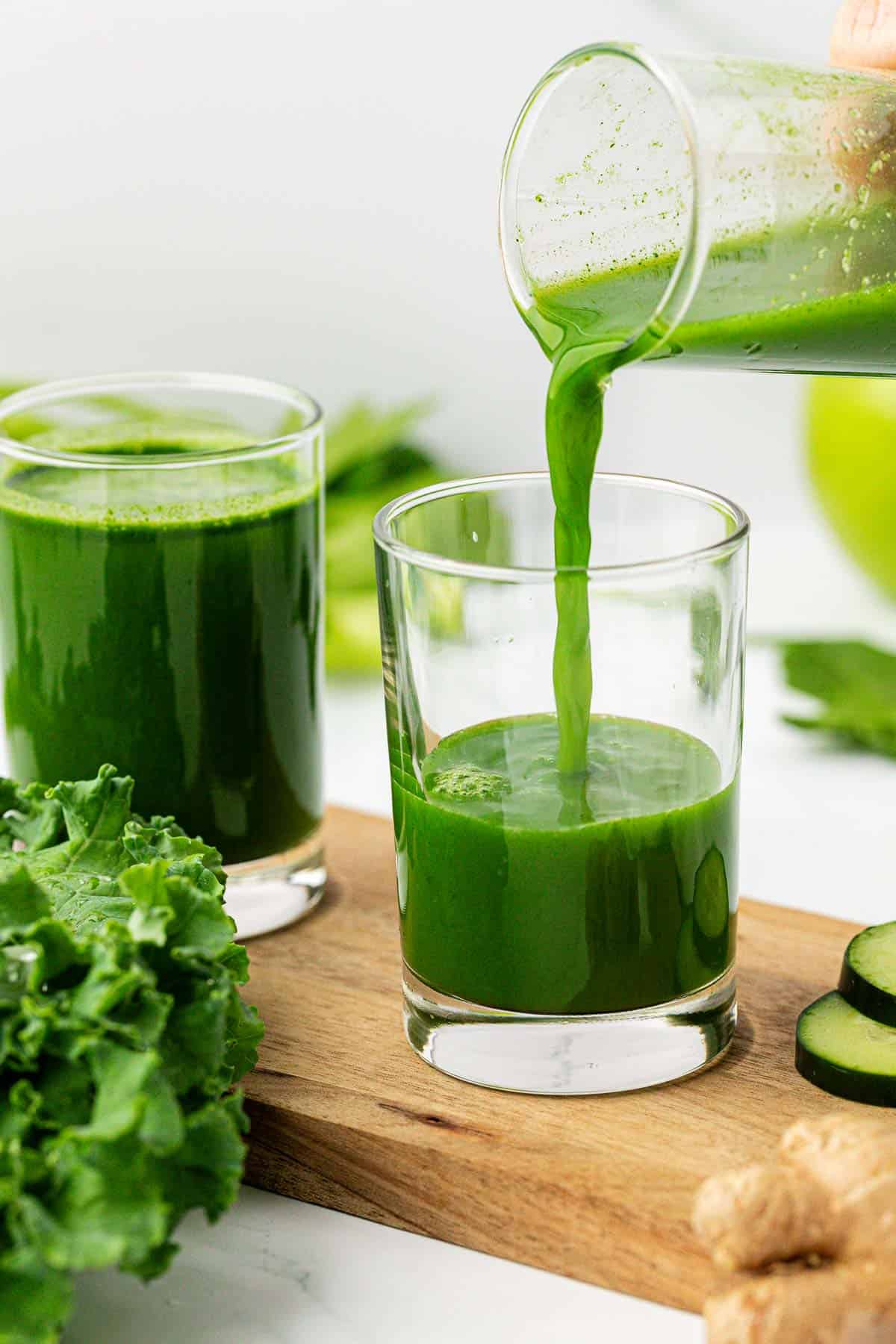 pouring green juice in a glass