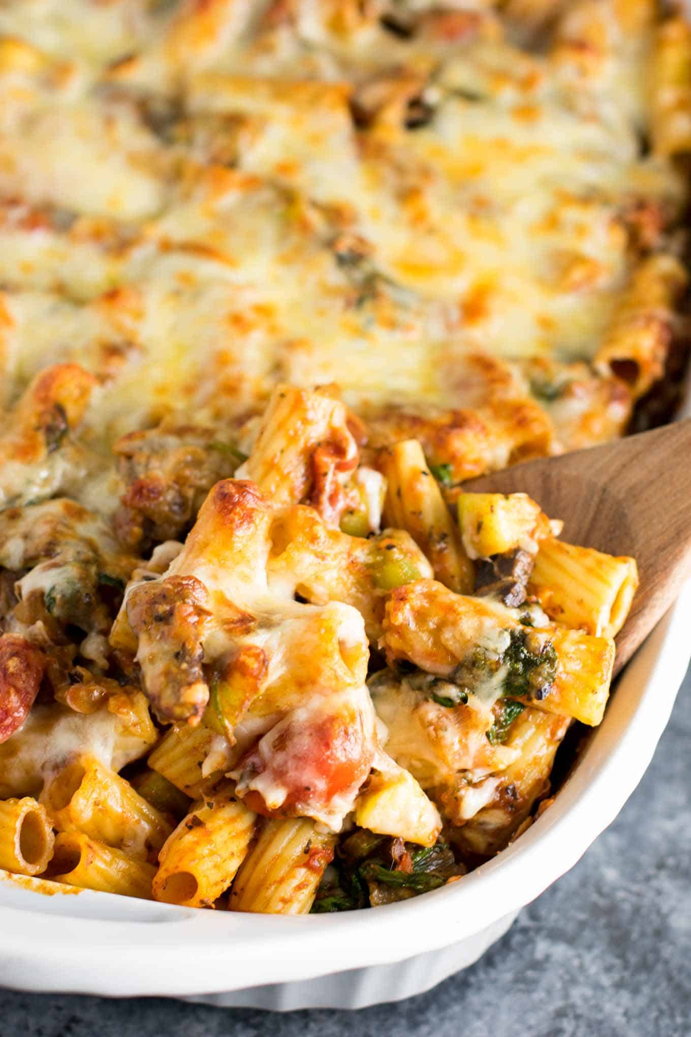 This veggie lover's baked rigatoni is packed full of cherry tomatoes, onions, garlic, mushrooms, bell peppers, zucchini, and spinach. A hearty and delicious vegetarian dinner!