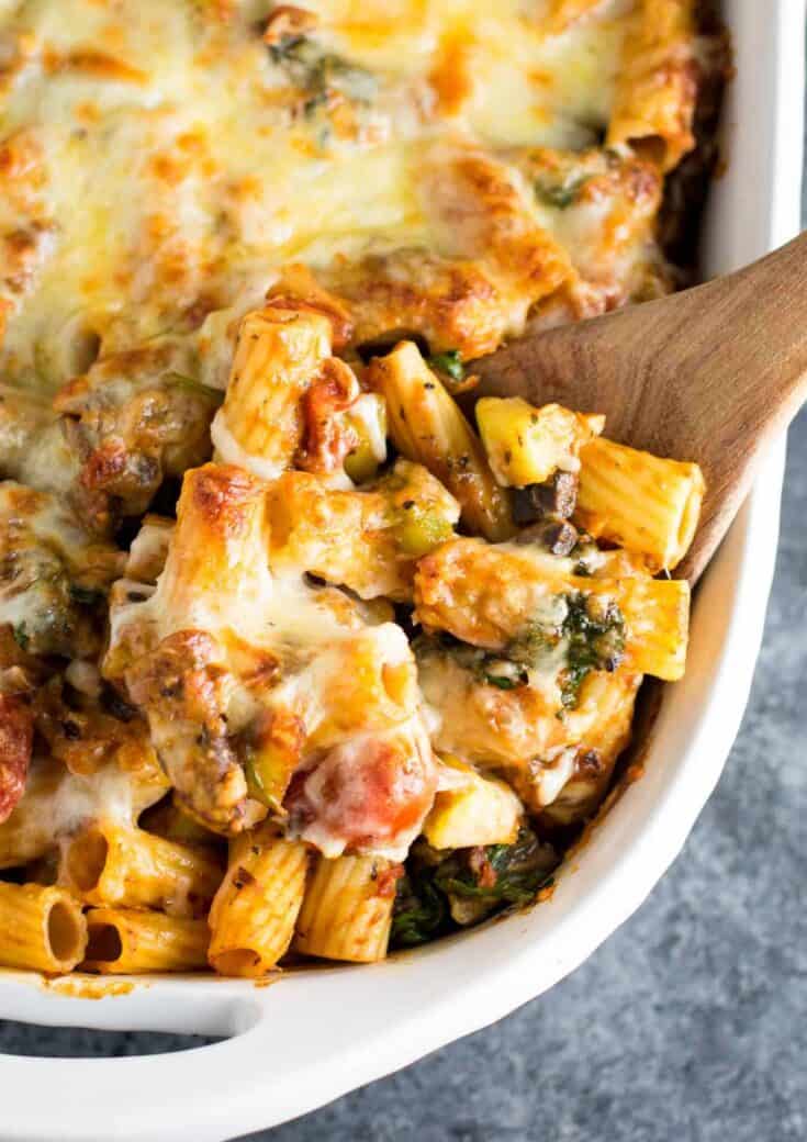 This veggie lover's baked rigatoni is packed full of cherry tomatoes, onions, garlic, mushrooms, bell peppers, zucchini, and spinach. A hearty and delicious vegetarian dinner!