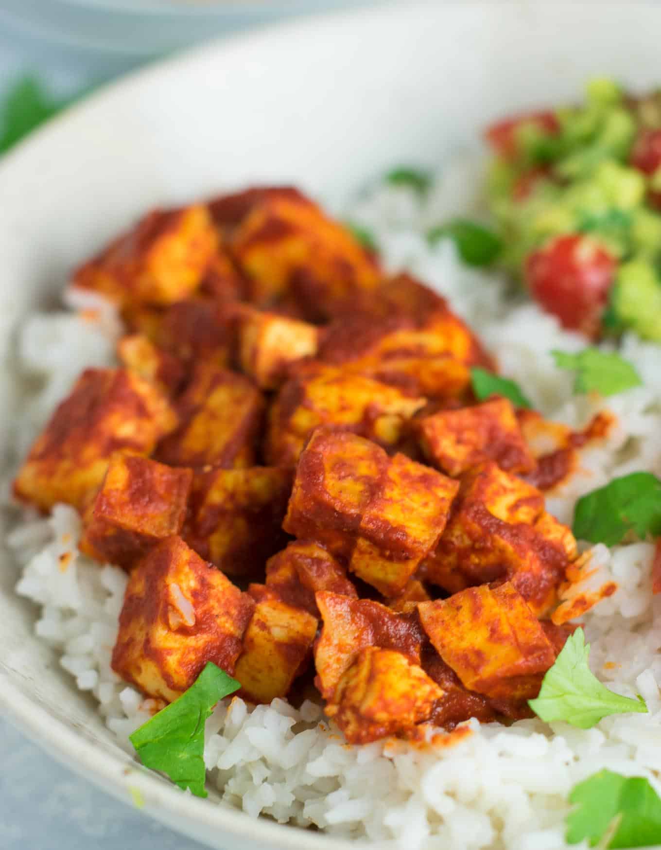 Easy enchilada tofu burrito bowls with homemade guacamole and salsa. Bring chipotle to your kitchen with this delicious recipe! #vegan #burritobowls #tofuburritobowls