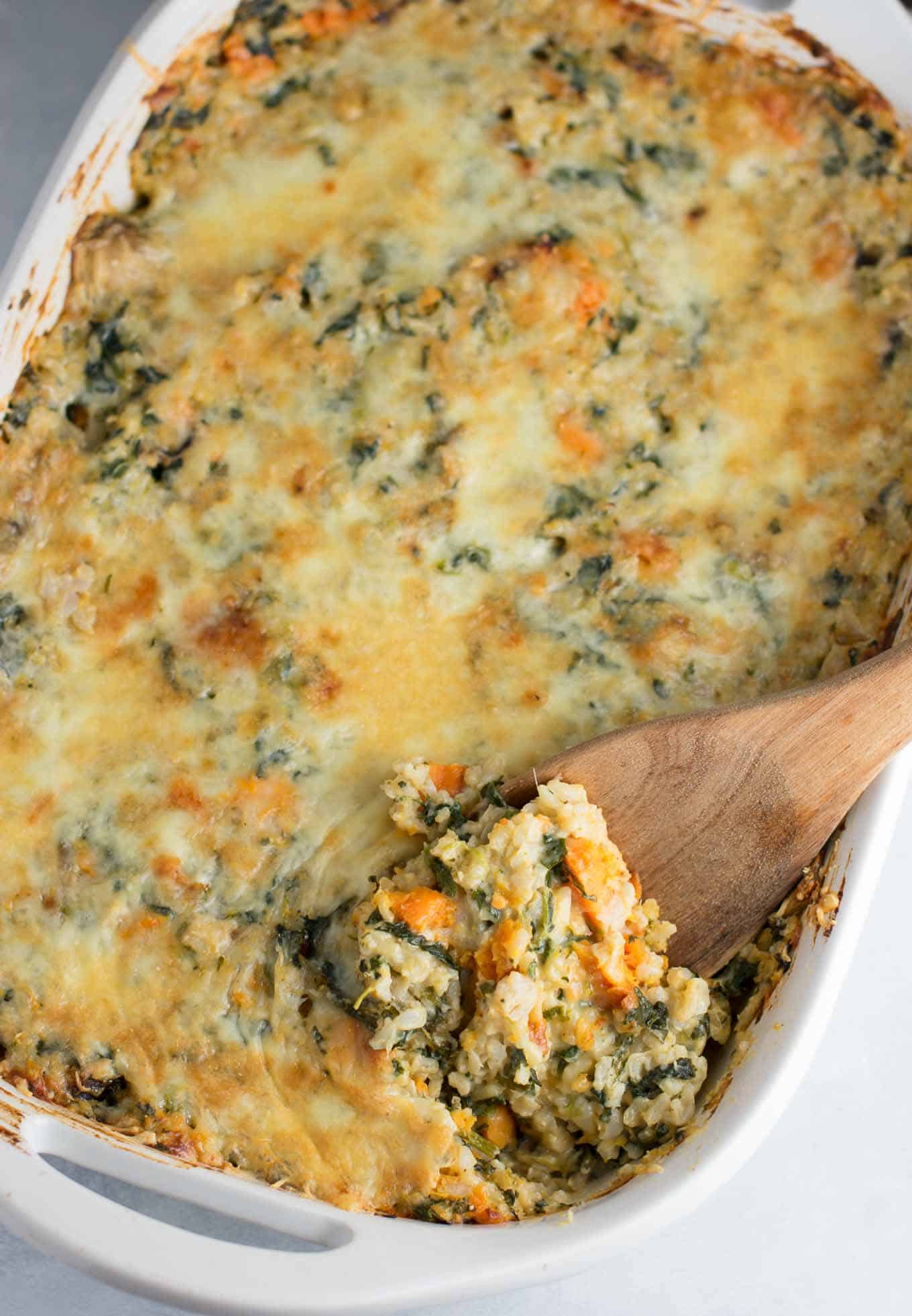 Sweet Potato Brown Rice Casserole made with greek yogurt, mushrooms, spinach, mozzarella, parmesan, and cheddar cheese - a hearty vegetarian comfort food recipe. No cream of anything soup! #casserole #vegetarian #sweetpotatobrownricecasserole #brownrice