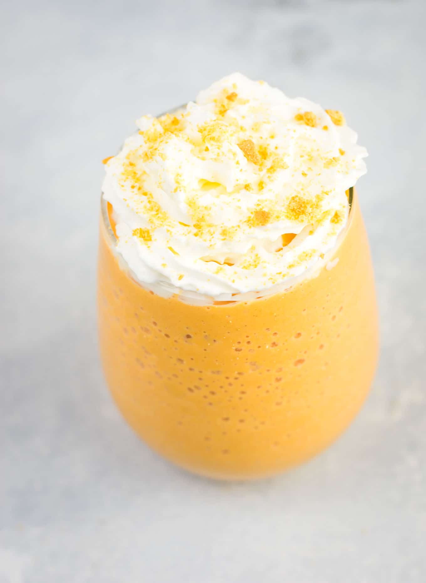 frozen pumpkin smoothie topped with whipped cream and crushed graham crackers