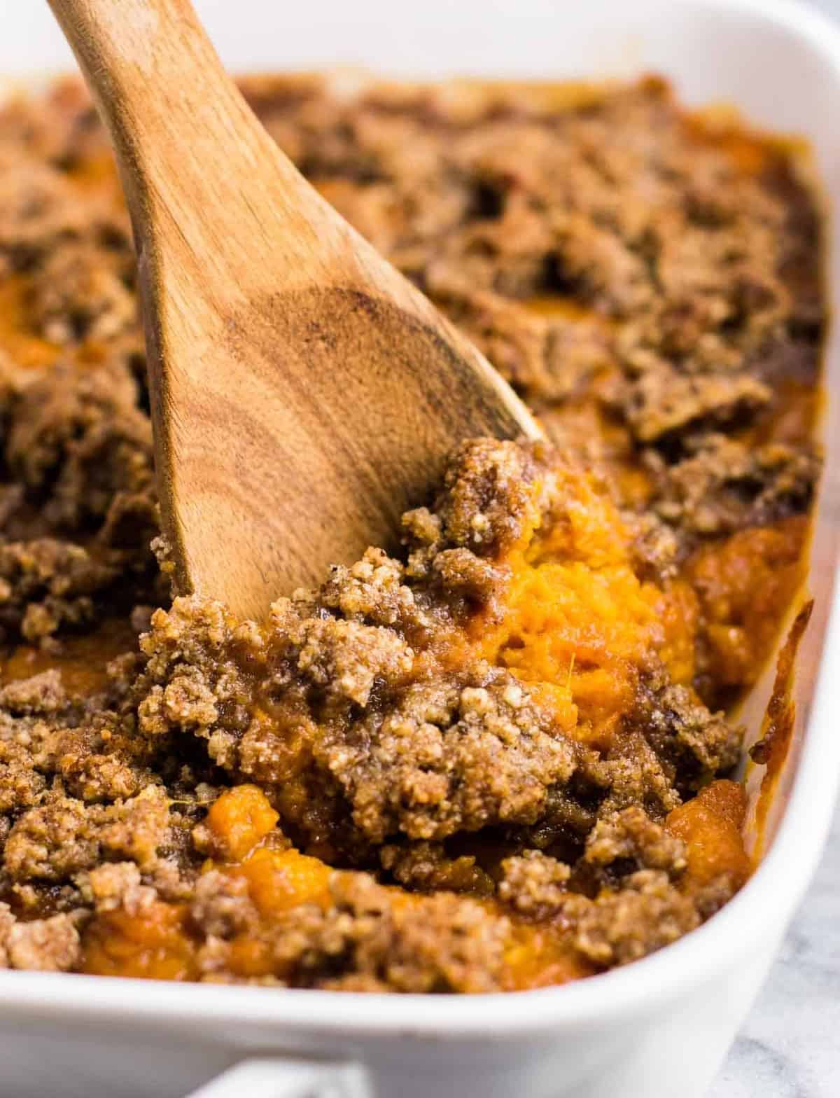 Gluten free sweet potato casserole with pecan crumble. This tastes incredible and everyone loves it! #sweetpotatocasserole #thanksgiving #pecans #glutenfree #vegetarian