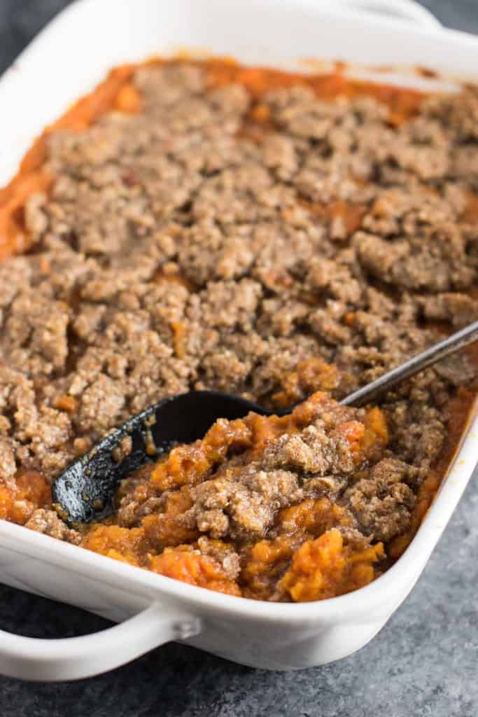 This sweet potato casserole with pecan crumble is the BEST side for your Thanksgiving table! Melt in your mouth buttery sweet potatoes are topped with a salty sweet gluten free pecan crumble. You will be fighting for seconds! #thanksgiving #sweetpotatocasserole #vegetarian #glutenfree