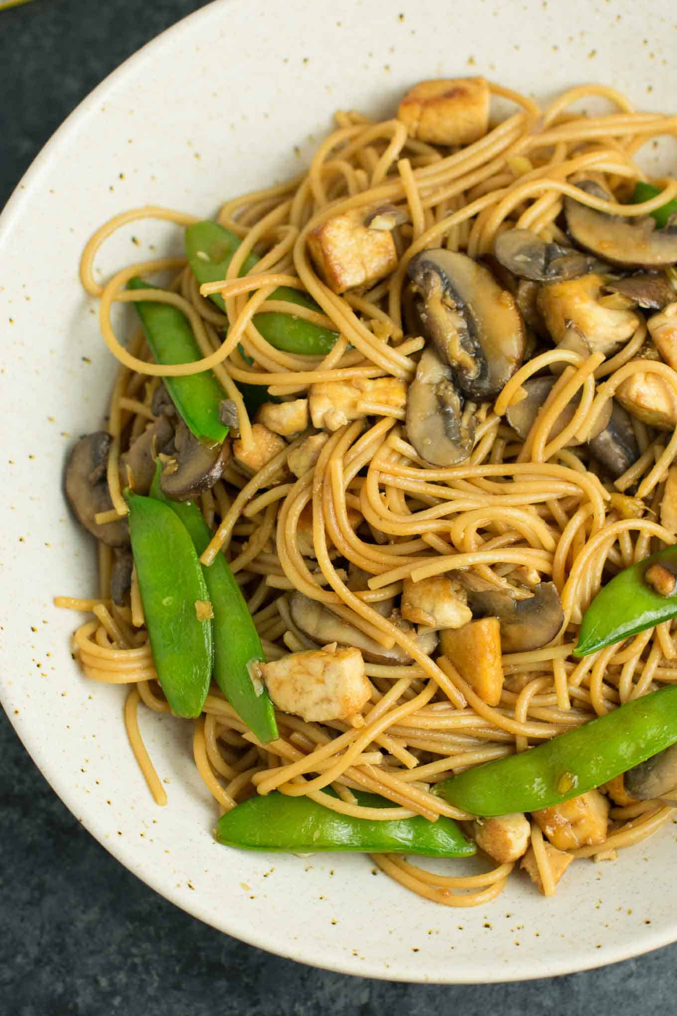 Easy Tofu Lo Mein recipe with fresh vegetables and a simple sauce. Ready in minutes and packed full of protein! #tofu #lomein #vegan #vegetarian