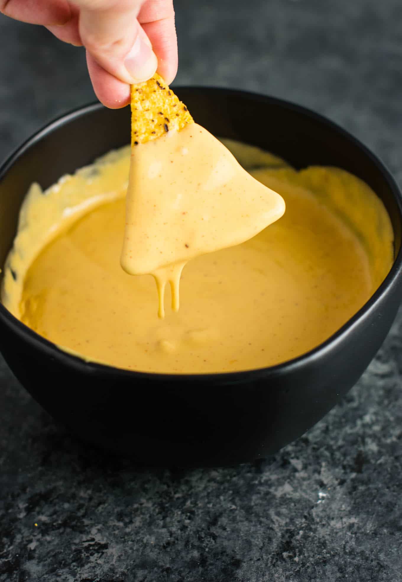 5 minute nacho cheese sauce recipe. Perfect for dipping, or poured over nachos! Just 6 ingredients! #nachocheesesauce #vegetarian #mexicanfood