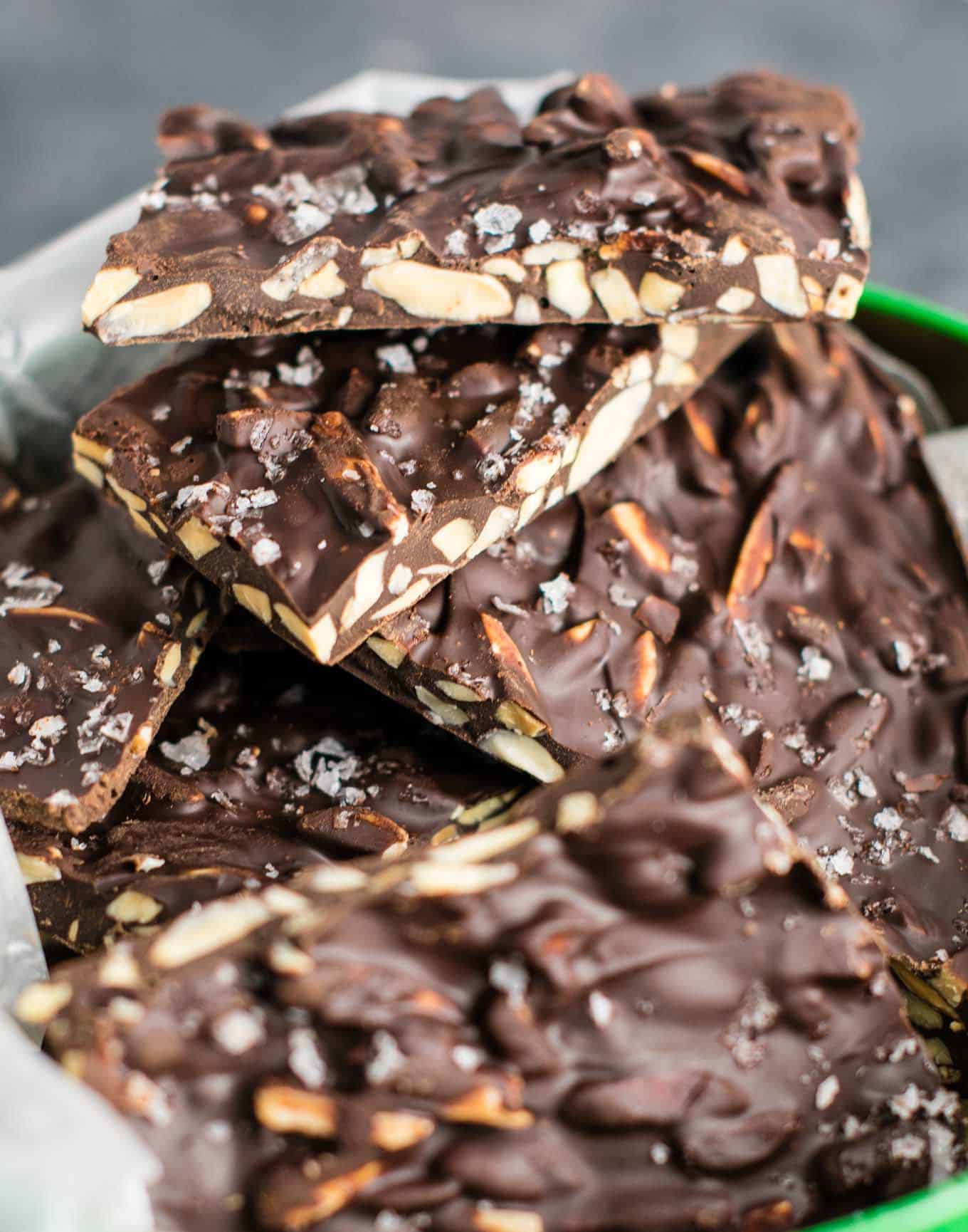 chocolate almond bark in a christmas tin lined with wax paper