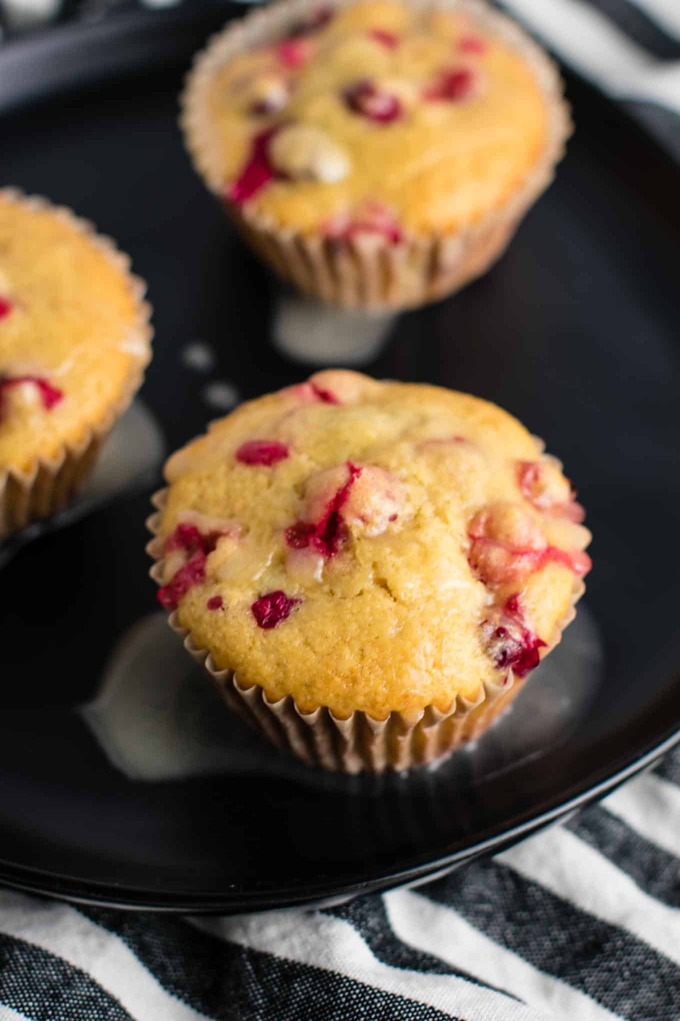 Healthy Cranberry Orange Muffins recipe made with greek yogurt and whole wheat pastry flour with a sweet orange glze. A healthier holiday breakfast or dessert! #breakfast #cranberry #muffins #cranberryorangemuffins #healthy