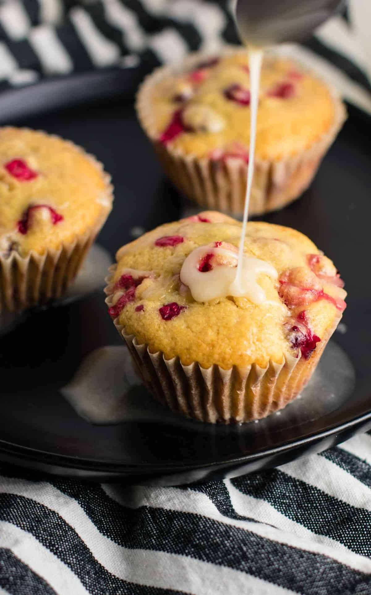 Healthy Cranberry Orange Muffins recipe made with greek yogurt and whole wheat pastry flour with a sweet orange glze. A healthier holiday breakfast or dessert! #breakfast #cranberry #muffins #cranberryorangemuffins #healthy