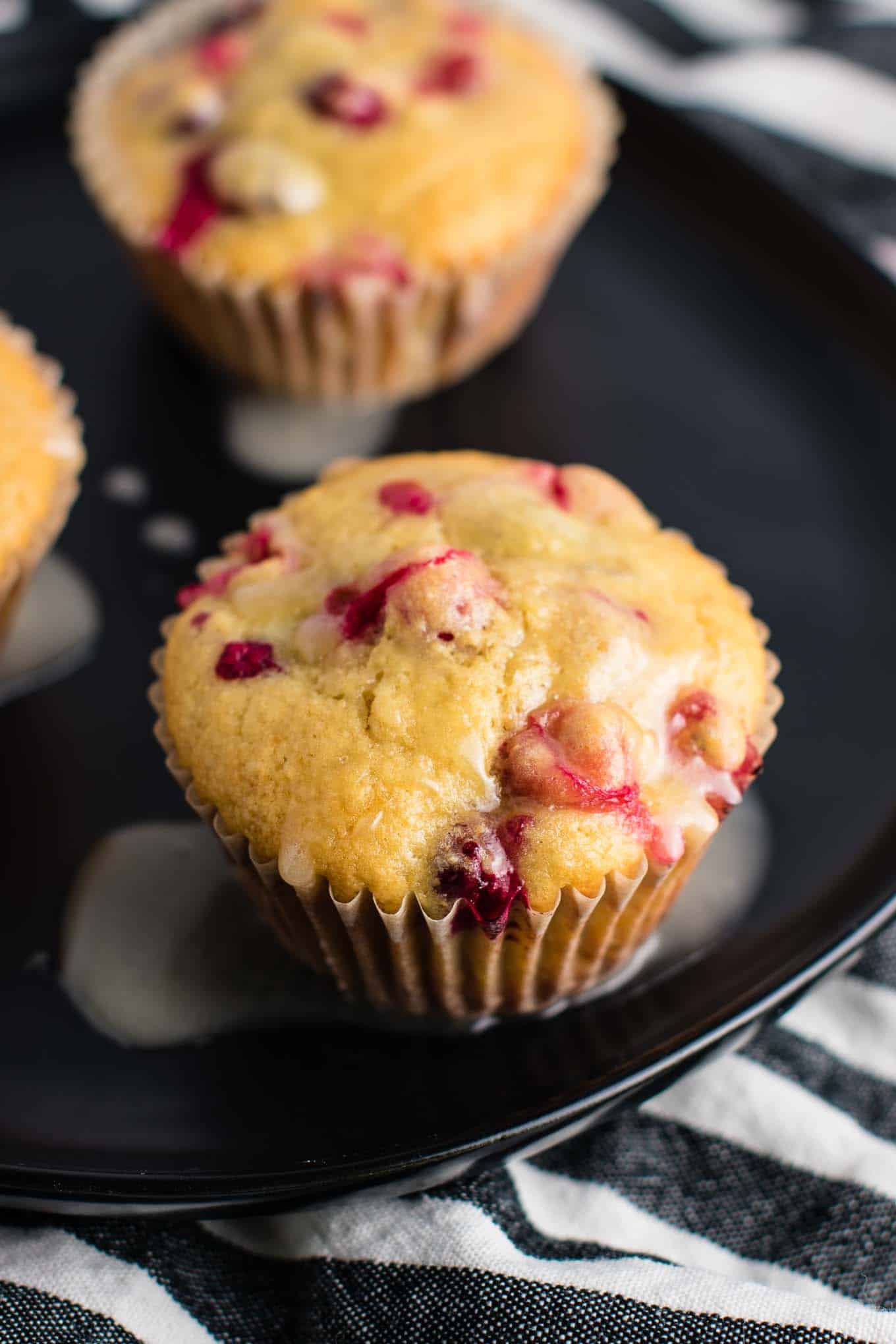 Healthy Cranberry Orange Muffins recipe made with greek yogurt and whole wheat pastry flour with a sweet orange glze. A healthier holiday breakfast or dessert! #breakfast #cranberry #muffins #cranberryorangemuffins #healthy