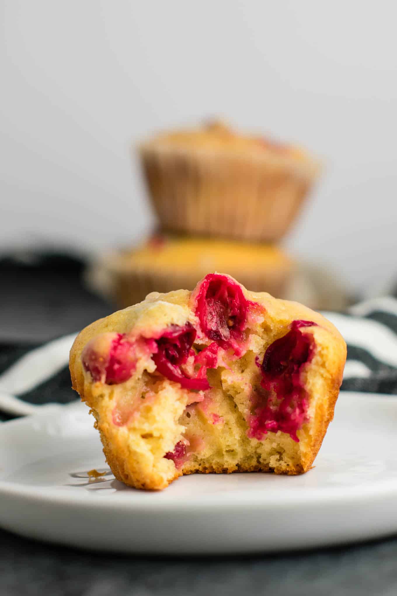 Healthy Cranberry Orange Muffins recipe made with greek yogurt and whole wheat pastry flour with a sweet orange glze. A healthier holiday breakfast or dessert! #breakfast #cranberry #muffins #cranberryorangemuffins #healthy