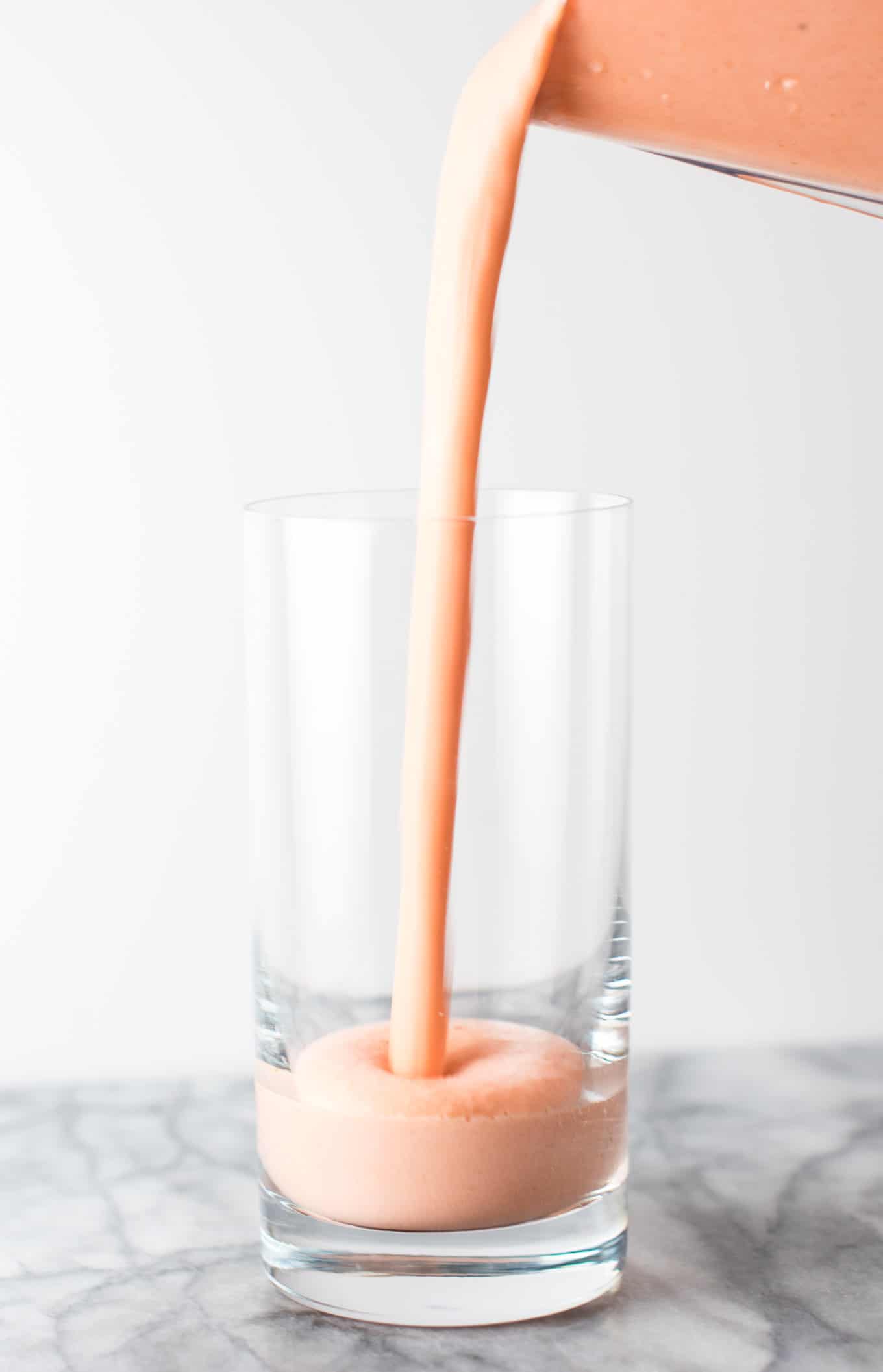 smoothie being poured into a glass