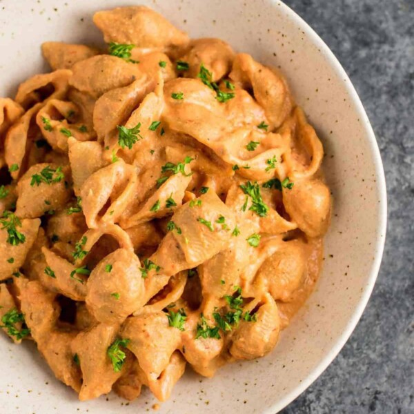 Creamy Tomato Shells are the ultimate vegan comfort food. Made with whole wheat pasta, and naturally creamy thanks to cashews and almond milk. You won’t believe how good this tastes! #vegan #creamsauce #creamytomatoshells #veganrecipe