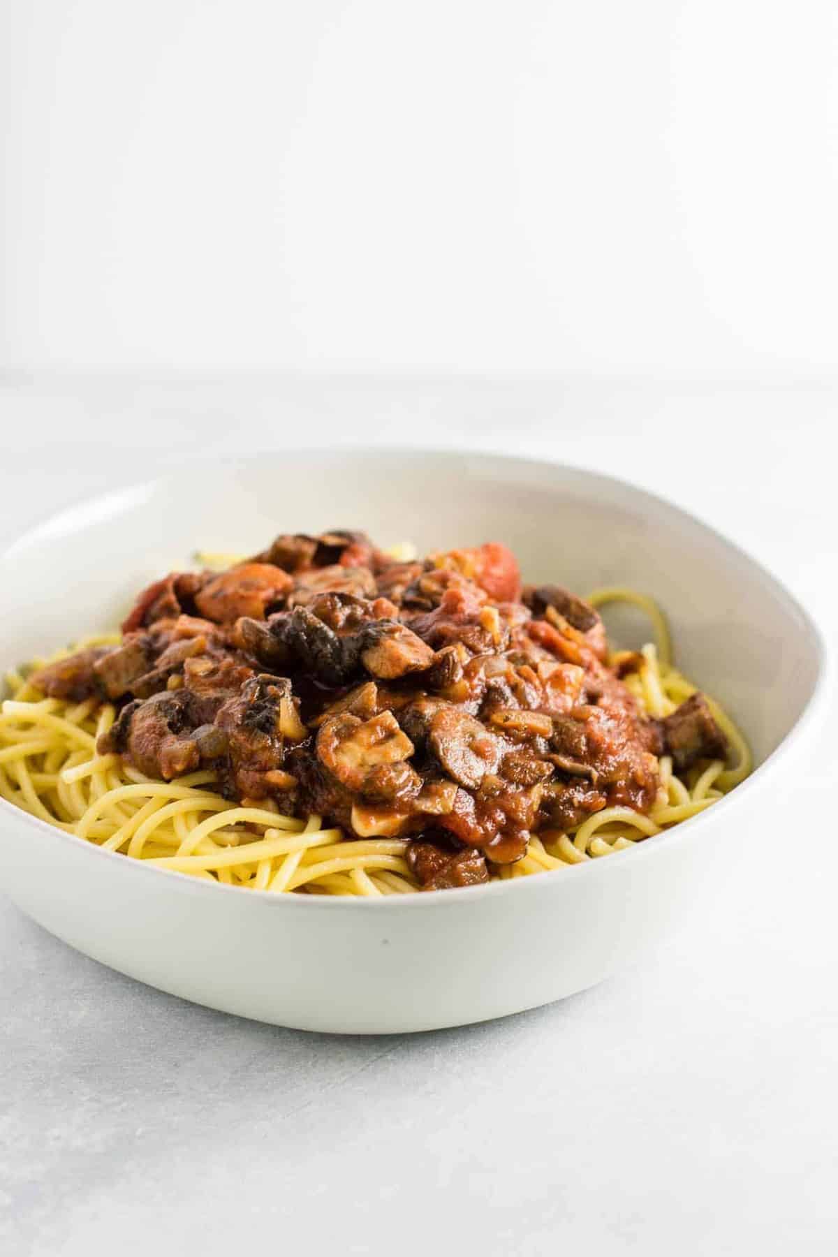 meatless spaghetti sauce over pasta in a white bowl