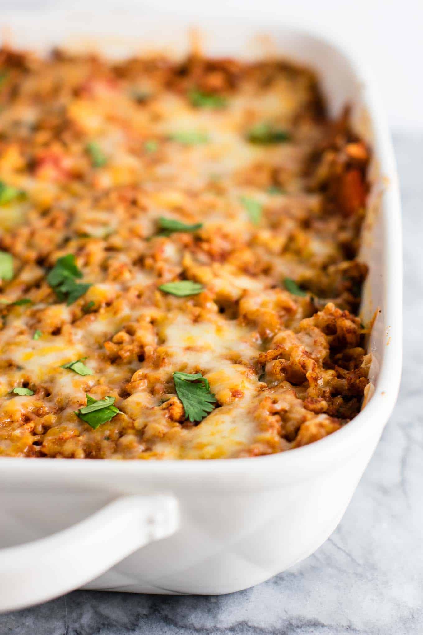 Tofu Mexican Rice Casserole Recipe with bell peppers and mushrooms. Scrambled tofu adds extra protein to this delicious vegetarian take on a healthier Mexican rice casserole. Serve with chips and sour cream! #tofumexicanrice #mexicanricecasserole #healthymexicanrice #tofu #vegetarian #dinner