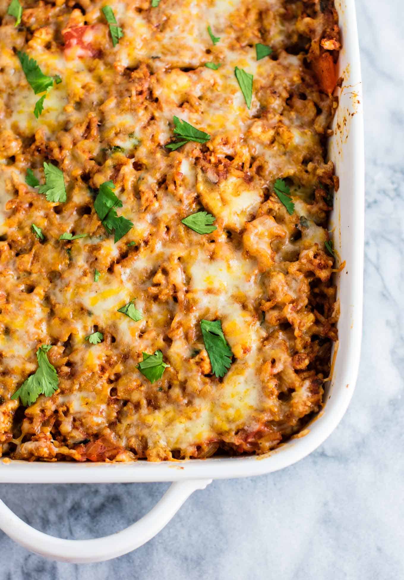 Tofu Mexican Rice Casserole Recipe with bell peppers and mushrooms. Scrambled tofu adds extra protein to this delicious vegetarian take on a healthier Mexican rice casserole. Serve with chips and sour cream! #tofumexicanrice #mexicanricecasserole #healthymexicanrice #tofu #vegetarian #dinner