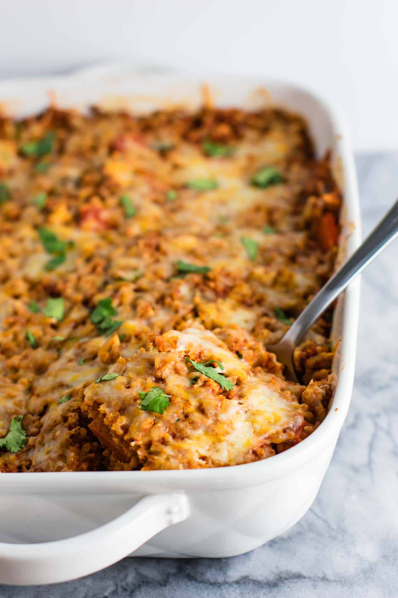 Tofu Mexican Rice Casserole Recipe with bell peppers and mushrooms. Scrambled tofu adds extra protein to this delicious vegetarian take on a healthier Mexican rice casserole. Serve with chips and sour cream! #tofumexicanrice #mexicanricecasserole #healthymexicanrice #tofu #vegetarian #dinner