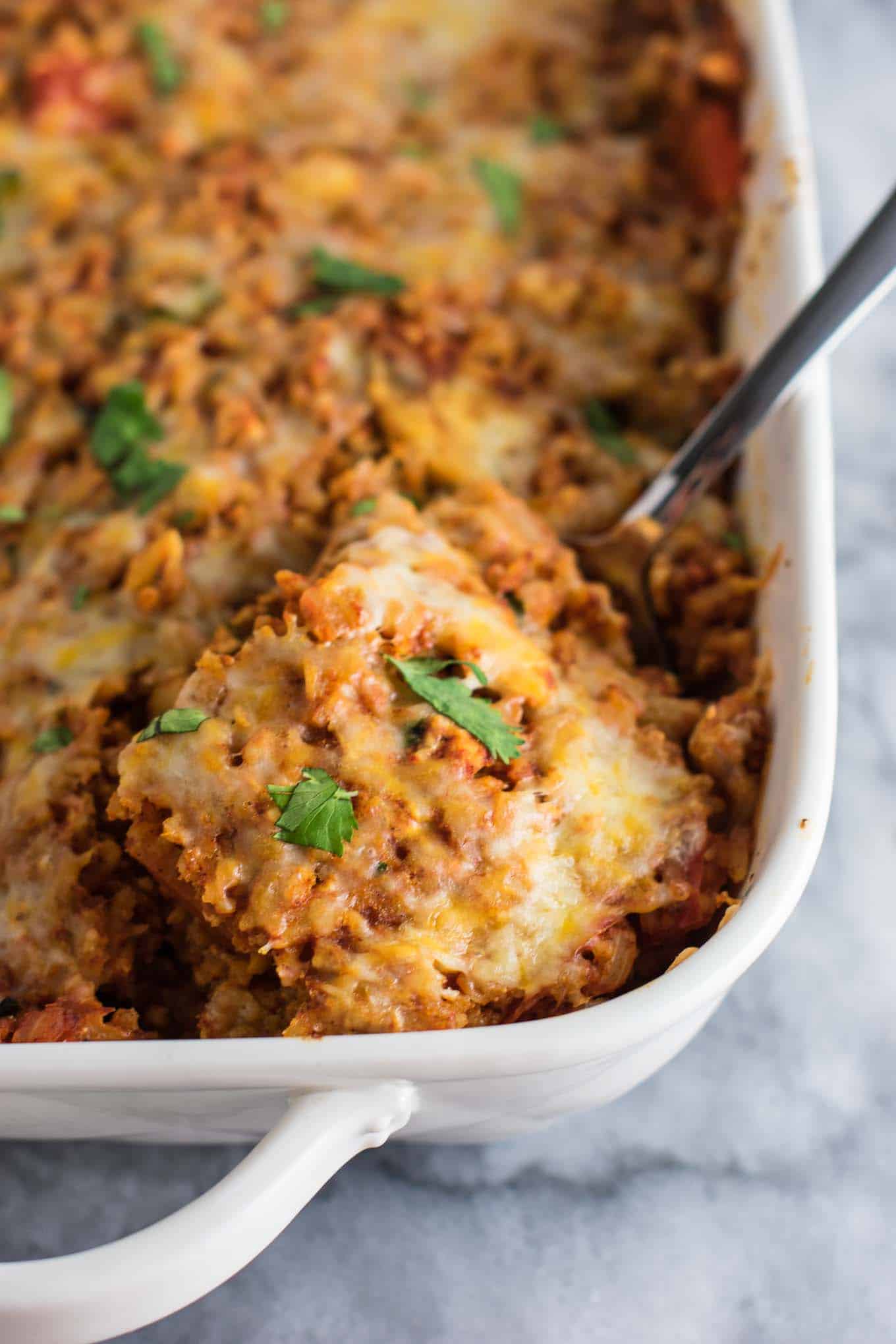 Tofu Mexican Rice Casserole Recipe with bell peppers and mushrooms. Scrambled tofu adds extra protein to this delicious vegetarian take on a healthier Mexican rice casserole. Serve with chips and sour cream! #tofumexicanrice #mexicanricecasserole #healthymexicanrice #tofu #vegetarian #dinner