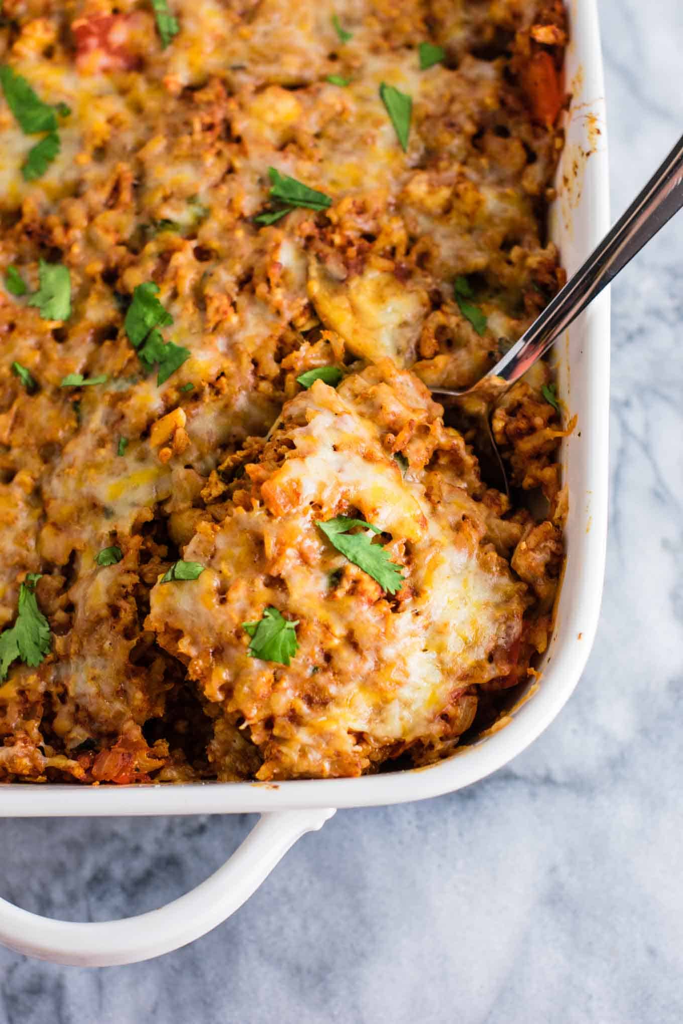 Tofu Mexican Rice Casserole Recipe with bell peppers and mushrooms. Scrambled tofu adds extra protein to this delicious vegetarian take on a healthier Mexican rice casserole. Serve with chips and sour cream! #tofumexicanrice #mexicanricecasserole #healthymexicanrice #tofu #vegetarian #dinner