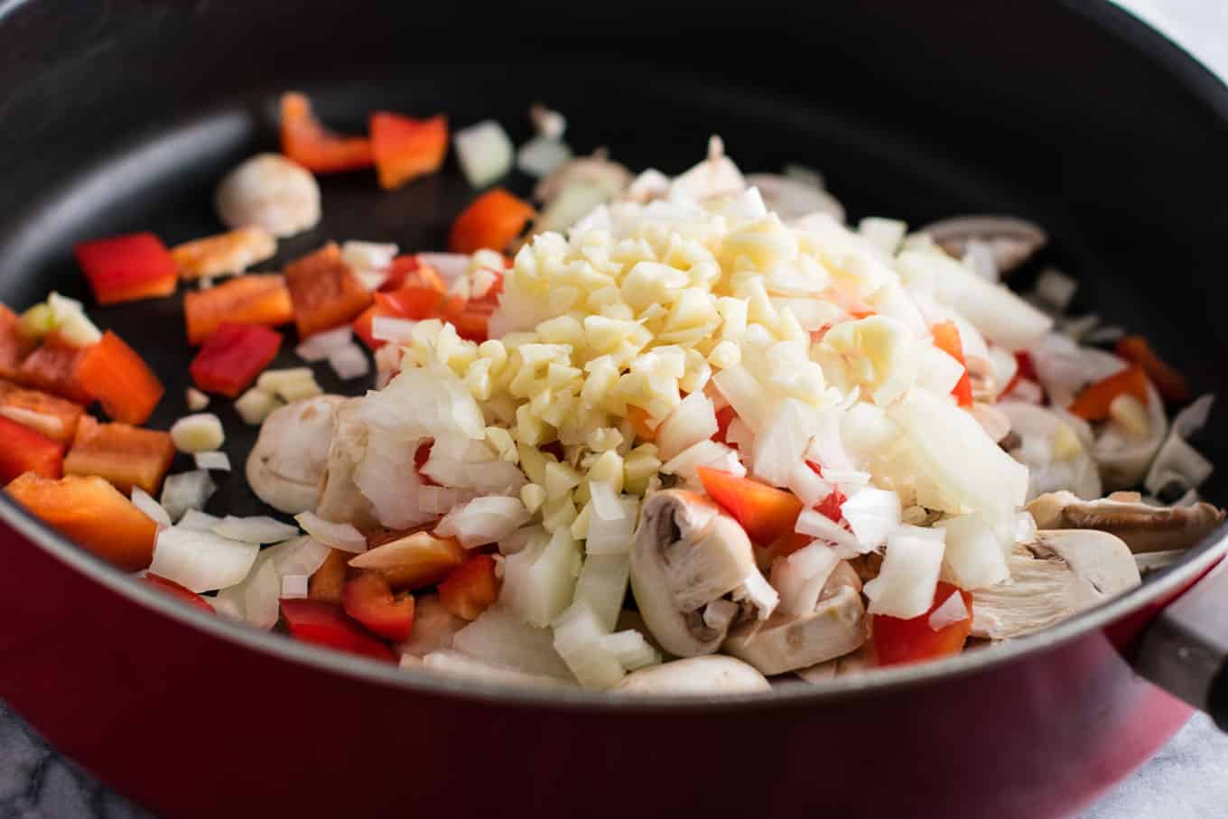 Tofu Mexican Rice Casserole Recipe with bell peppers and mushrooms. Scrambled tofu adds extra protein to this delicious vegetarian take on a healthier Mexican rice casserole. Serve with chips and sour cream! #tofumexicanrice #mexicanricecasserole #healthymexicanrice #tofu #vegetarian #dinner