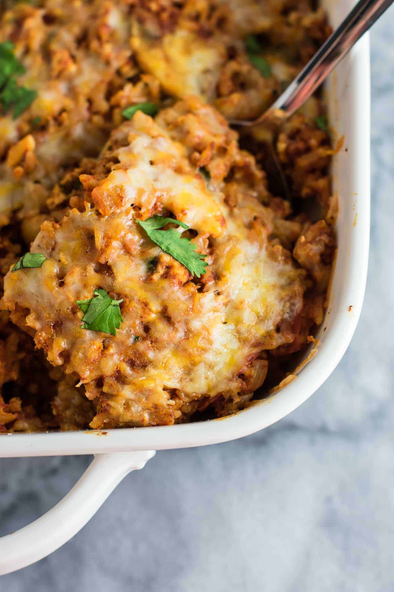 Tofu Mexican Rice Casserole Recipe with bell peppers and mushrooms. Scrambled tofu adds extra protein to this delicious vegetarian take on a healthier Mexican rice casserole. Serve with chips and sour cream! #tofumexicanrice #mexicanricecasserole #healthymexicanrice #tofu #vegetarian #dinner