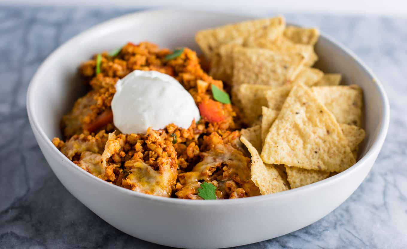 Tofu Mexican Rice Casserole Recipe with bell peppers and mushrooms. Scrambled tofu adds extra protein to this delicious vegetarian take on a healthier Mexican rice casserole. Serve with chips and sour cream! #tofumexicanrice #mexicanricecasserole #healthymexicanrice #tofu #vegetarian #dinner