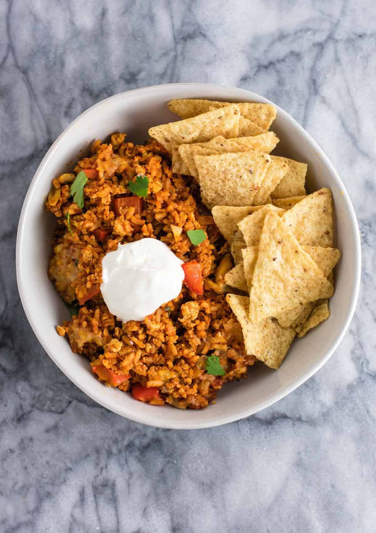 Tofu Mexican Rice Casserole Recipe with bell peppers and mushrooms. Scrambled tofu adds extra protein to this delicious vegetarian take on a healthier Mexican rice casserole. Serve with chips and sour cream! #tofumexicanrice #mexicanricecasserole #healthymexicanrice #tofu #vegetarian #dinner