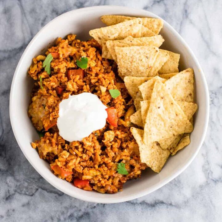 Tofu Mexican Rice Casserole Recipe with bell peppers and mushrooms. Scrambled tofu adds extra protein to this delicious vegetarian take on a healthier Mexican rice casserole. Serve with chips and sour cream! #tofumexicanrice #mexicanricecasserole #healthymexicanrice #tofu #vegetarian #dinner