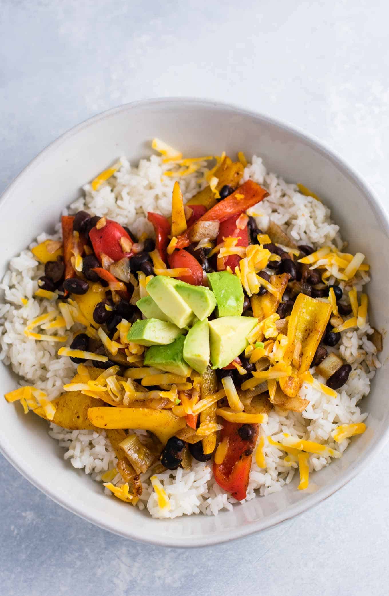 Vegetarian burrito bowl recipe with black beans, mini bell peppers, garlic, and onion. Better than chipotle! An easy vegetarian meal prep recipe or dinner the whole family will love! #vegetarianmealprep #vegetarianburritobowl #dinner #healthy #vegetarian