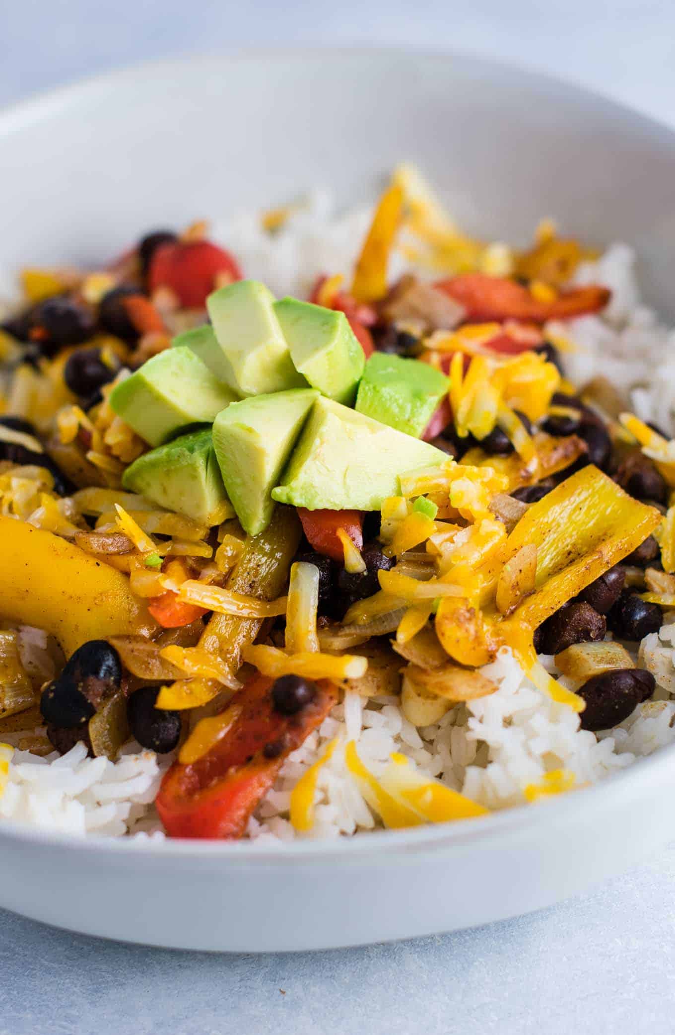 Vegetarian burrito bowl recipe with black beans, mini bell peppers, garlic, and onion. Better than chipotle! An easy vegetarian meal prep recipe or dinner the whole family will love! #vegetarianmealprep #vegetarianburritobowl #dinner #healthy #vegetarian