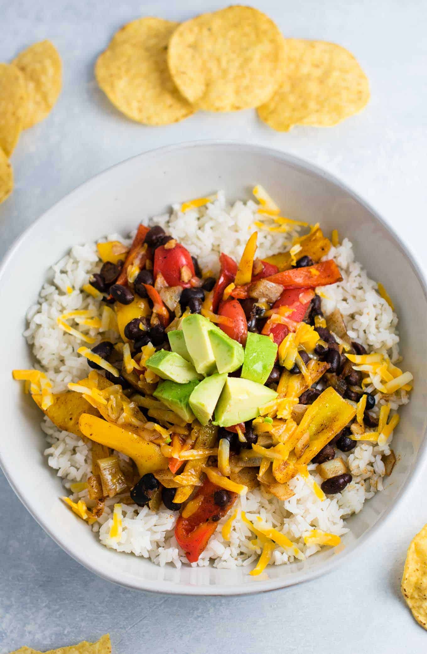 Vegetarian burrito bowl recipe with black beans, mini bell peppers, garlic, and onion. Better than chipotle! An easy vegetarian meal prep recipe or dinner the whole family will love! #vegetarianmealprep #vegetarianburritobowl #dinner #healthy #vegetarian