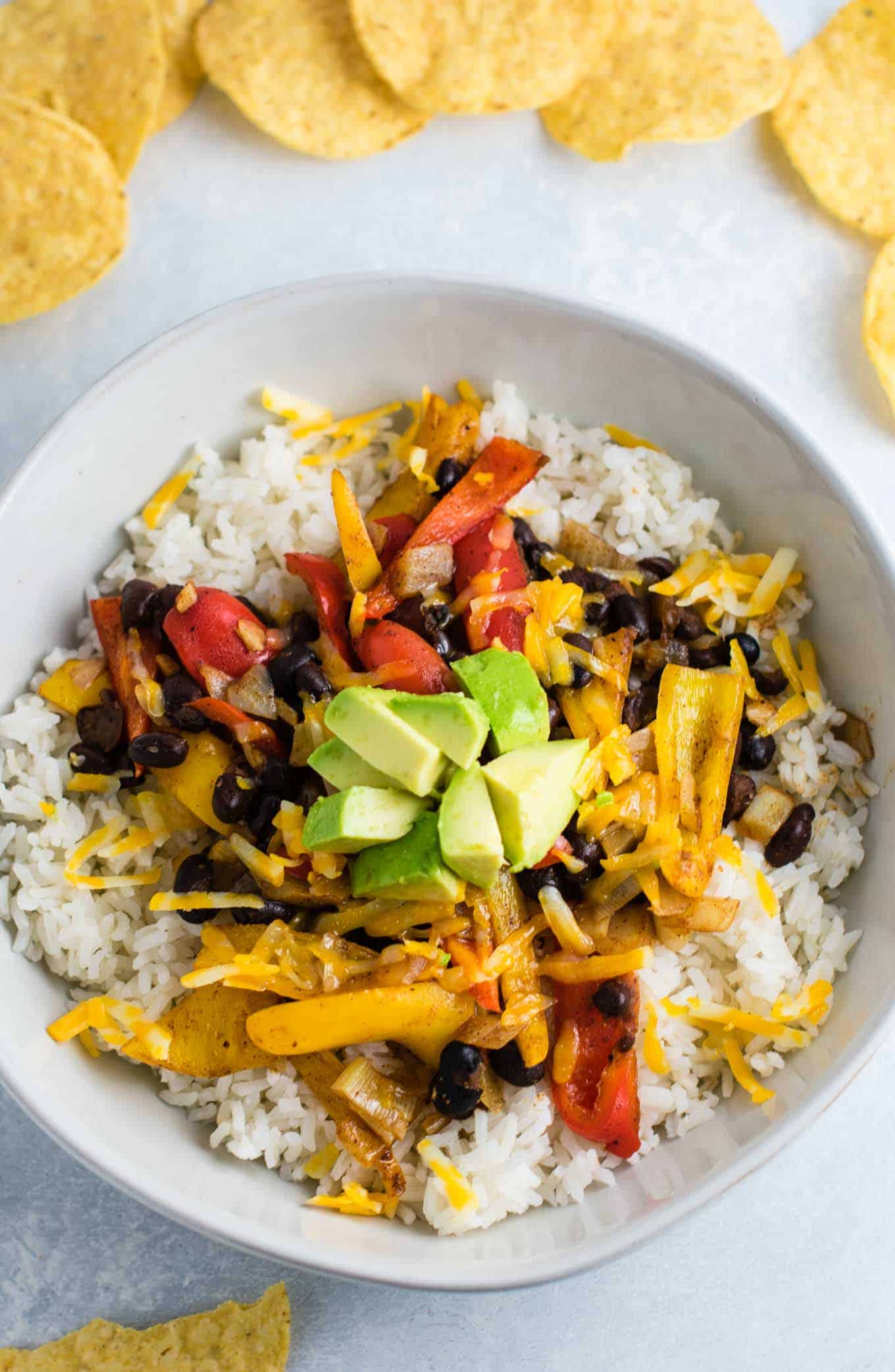 Vegetarian burrito bowl recipe with black beans, mini bell peppers, garlic, and onion. Better than chipotle! An easy vegetarian meal prep recipe or dinner the whole family will love! #vegetarianmealprep #vegetarianburritobowl #dinner #healthy #vegetarian