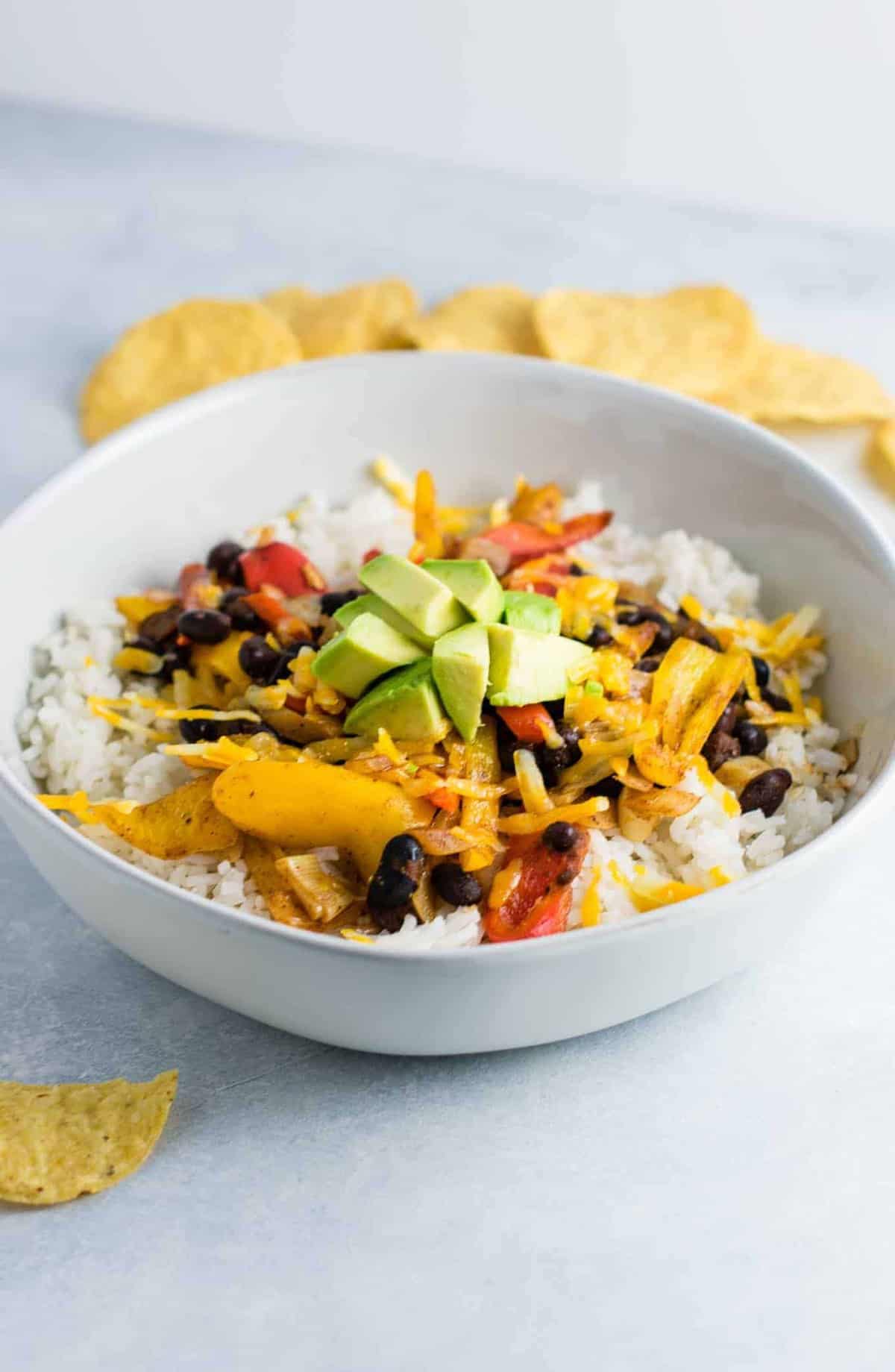 Vegetarian burrito bowl recipe with black beans, mini bell peppers, garlic, and onion. Better than chipotle! An easy vegetarian meal prep recipe or dinner the whole family will love! #vegetarianmealprep #vegetarianburritobowl #dinner #healthy #vegetarian