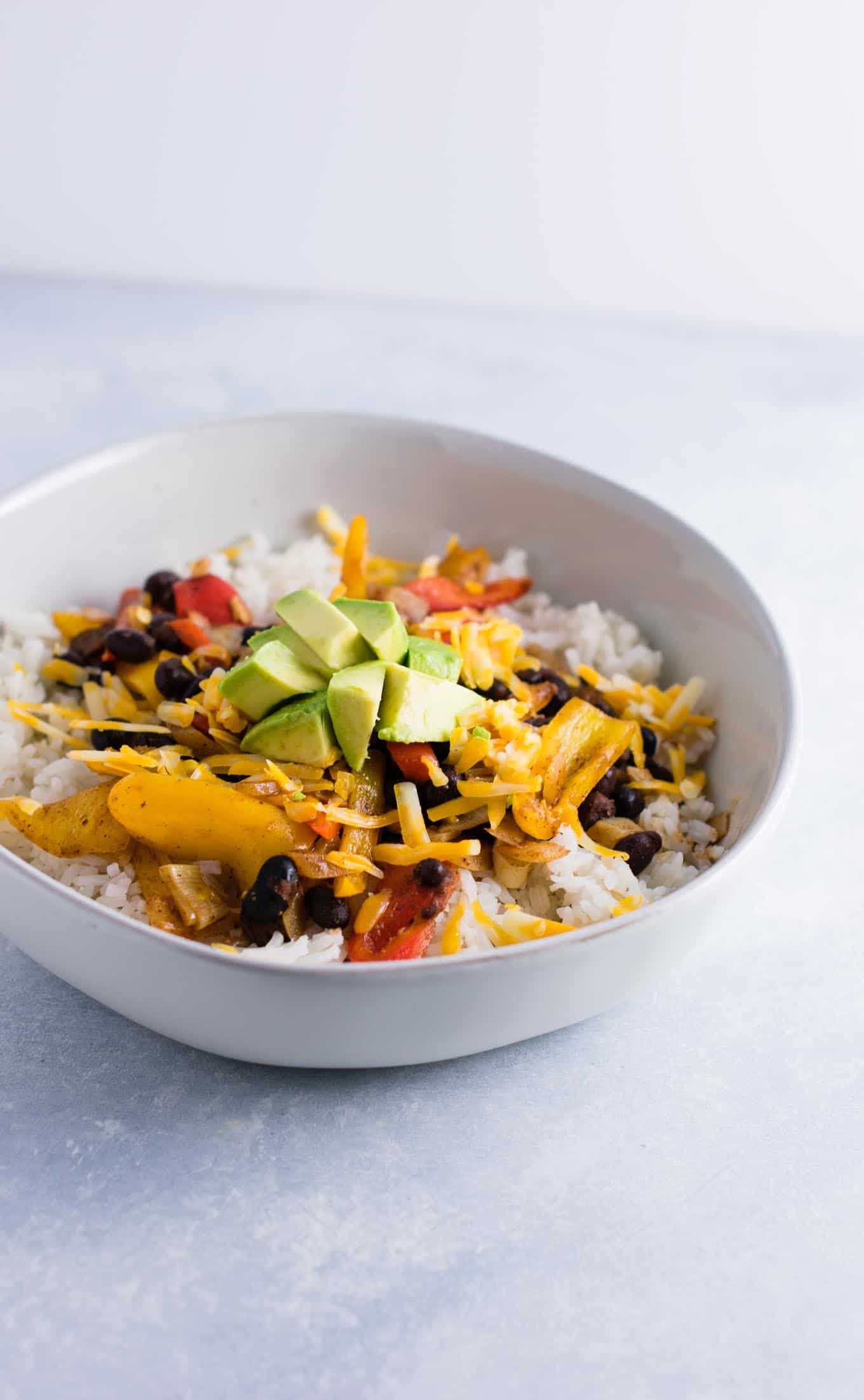 Vegetarian burrito bowl recipe with black beans, mini bell peppers, garlic, and onion. Better than chipotle! An easy vegetarian meal prep recipe or dinner the whole family will love! #vegetarianmealprep #vegetarianburritobowl #dinner #healthy #vegetarian