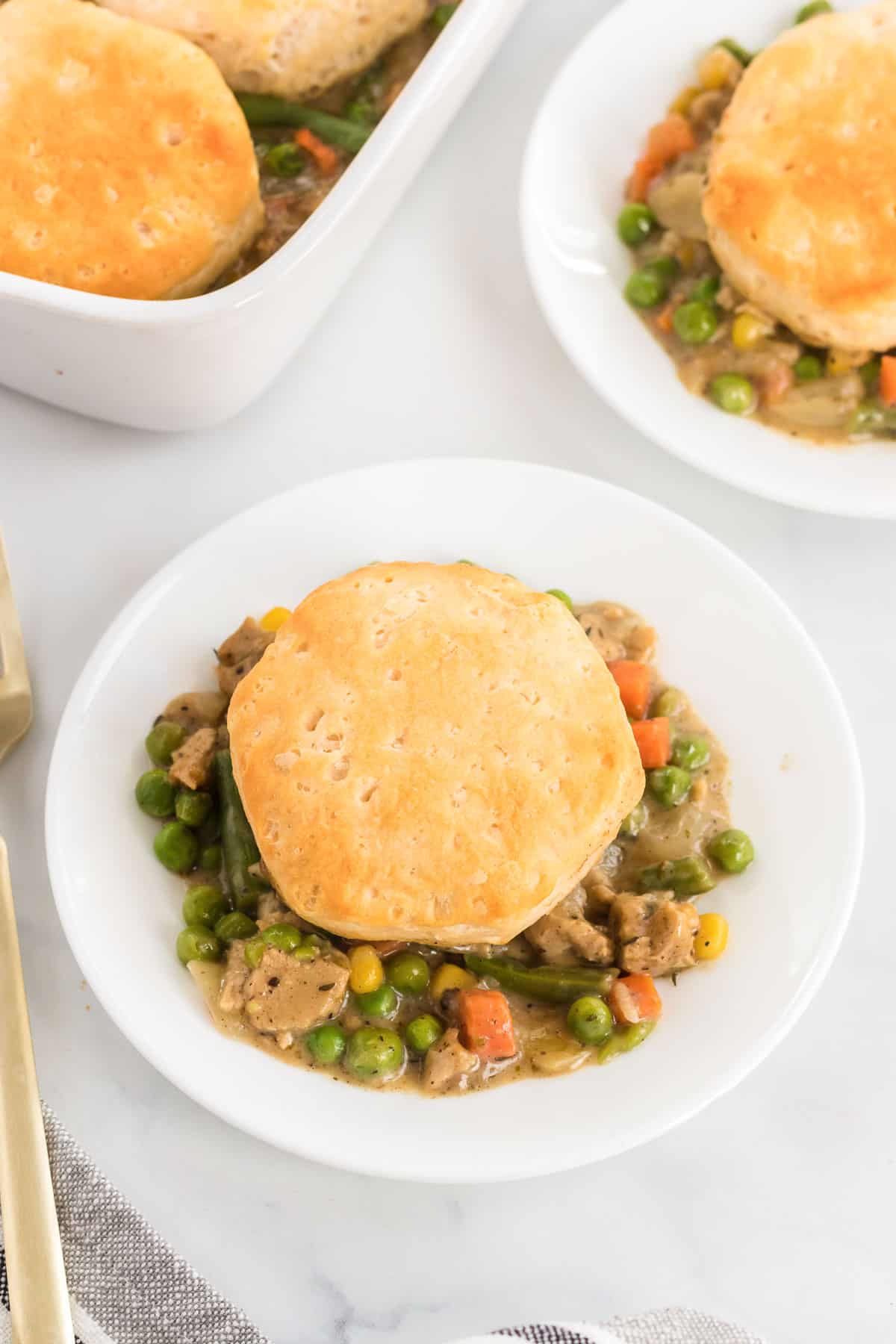 veggie pot pie topped with a biscuit on a plate