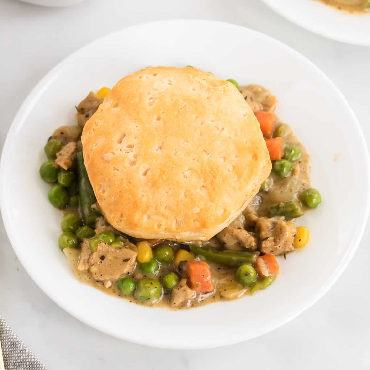 veggie pot pie topped with a biscuit on a plate