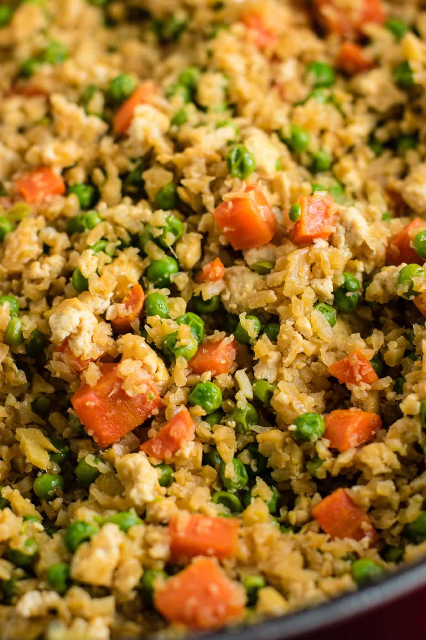 This cauliflower tofu fried rice is vegan, gluten free, grain free, and low carb. You won't believe this doesn't have rice or eggs in it! My new favorite dinner recipe! #grainfree #glutenfree #cauliflowerfriedrice #tofufriedrice #vegan #dinner #eggfree