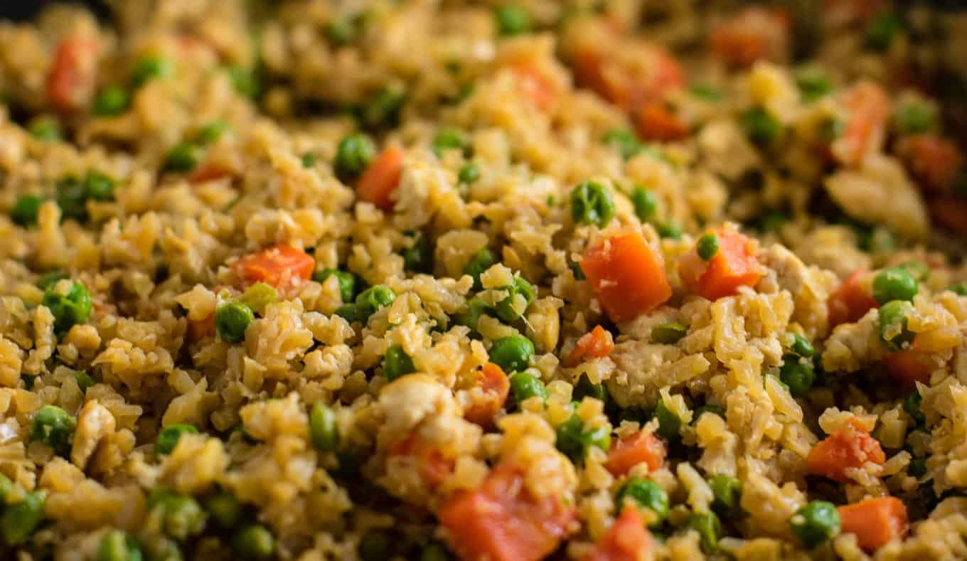 This cauliflower tofu fried rice is vegan, gluten free, grain free, and low carb. You won't believe this doesn't have rice or eggs in it! My new favorite dinner recipe! #grainfree #glutenfree #cauliflowerfriedrice #tofufriedrice #vegan #dinner #eggfree