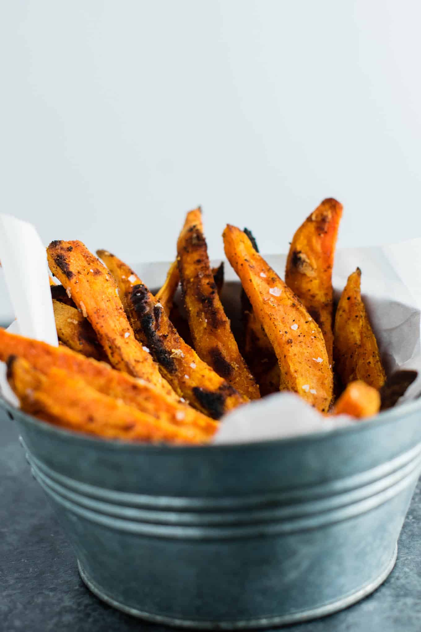 I am obsessed with these roasted sweet potato fries! The perfect combo of salty sweet and the spices are perfect. So easy and go with everything! #sweetpotatofries #vegetables #sidedish #vegan #dinner #roastedsweetpotatofries
