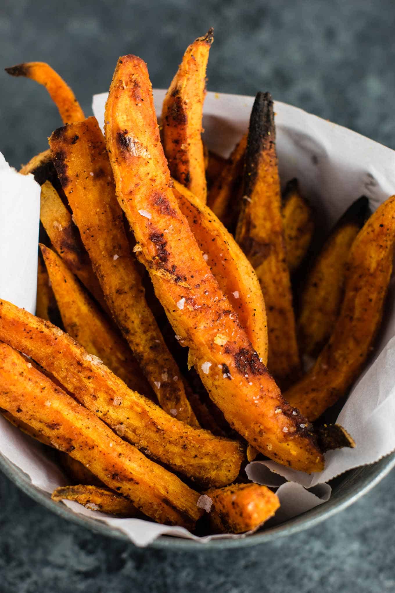 I am obsessed with these roasted sweet potato fries! The perfect combo of salty sweet and the spices are perfect. So easy and go with everything! #sweetpotatofries #vegetables #sidedish #vegan #dinner #roastedsweetpotatofries